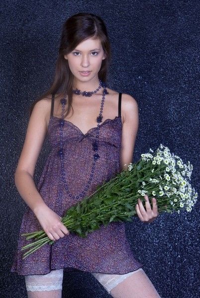 young brunette girl with purple clothes and flowers