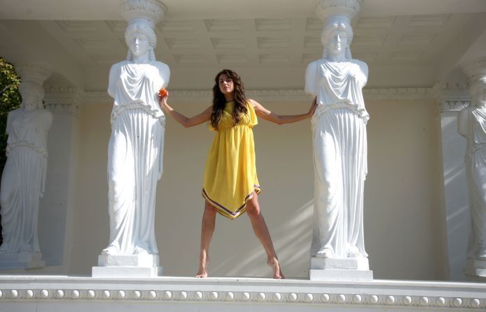young brunette girl and statues