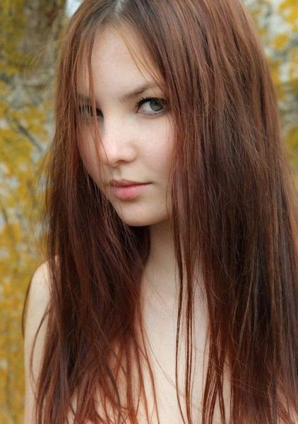 young red haired girl in the nature