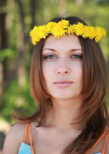 brunette girl with a wreath of dandelions