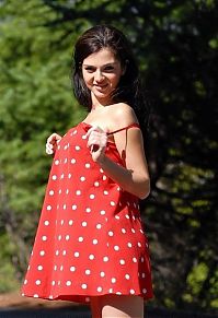 Nake.Me search results: young brunette girl reveals in a red dress with white dots outside on the road