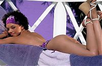 Babes: black girl with a purple scarf posing on the terrace