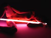 Nake.Me search results: cute young brunette girl posing with a neon tube lamp