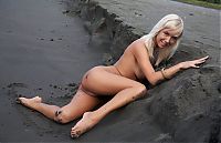Babes: young swedish blonde girl on the sand and mud bank with a driftwood and remains of trees