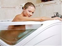 Babes: young blonde girl with long hair reveals in the bathtub with a small ship