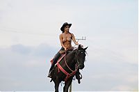 Nake.Me search results: brunette girl shows off her cowboy skills with a horse and colt revolver