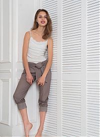 Babes: young brunette girl reveals her white shirt and pants in the room with a wardrobe closet