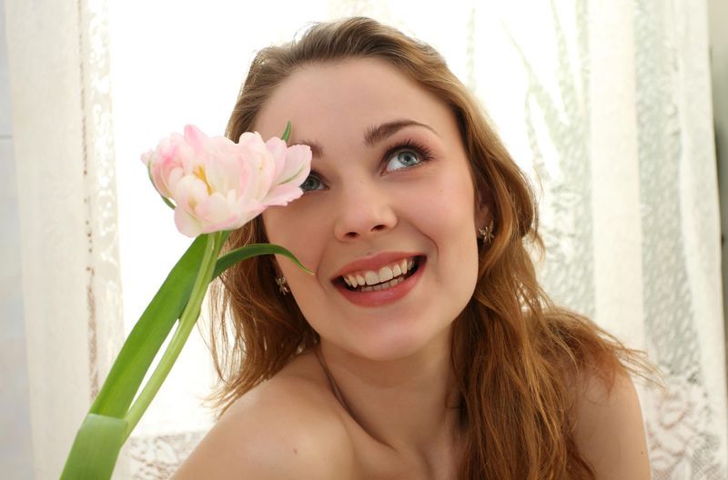 young red haired girl with flower