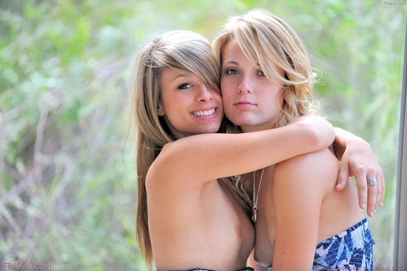 two young blonde girls couple taking off their clothes