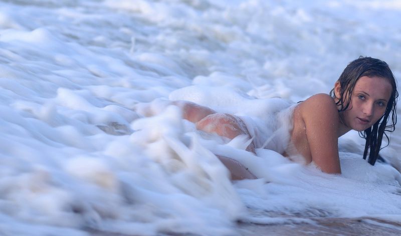 young brunette girl wet during high tide