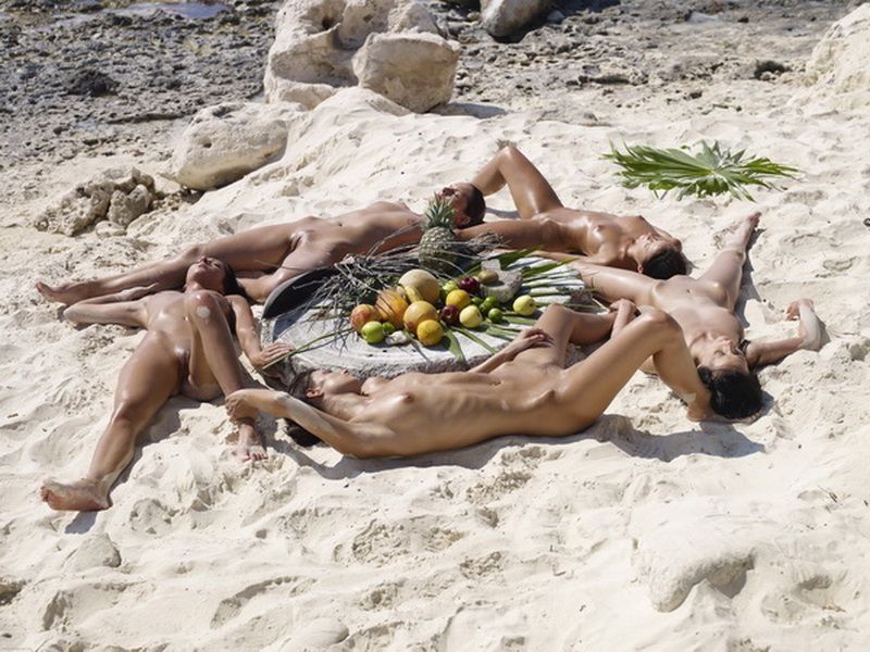 girls at the beach lying in the sand
