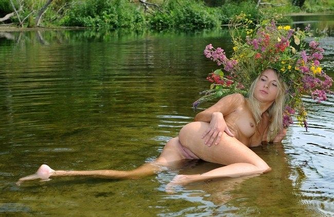 young blonde fairy girl by the lake