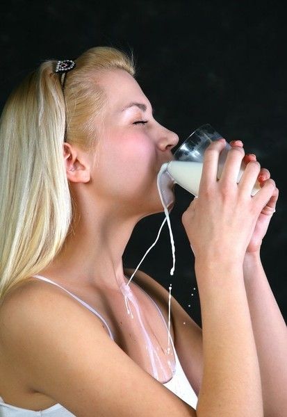 young blonde girl going crazy with milk