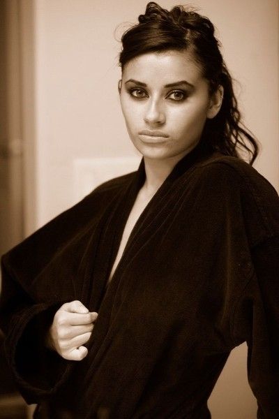 brunette girl wearing a bathrobe in the bathroom