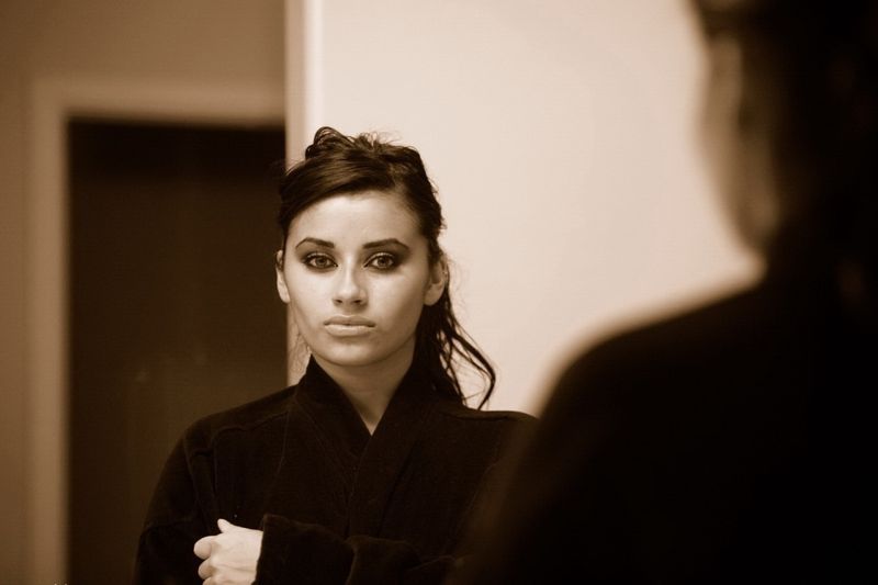 brunette girl wearing a bathrobe in the bathroom