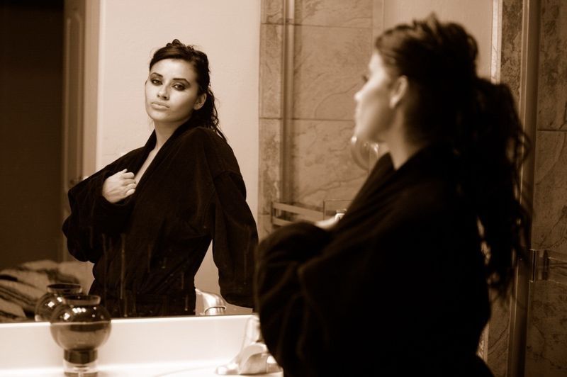 brunette girl wearing a bathrobe in the bathroom