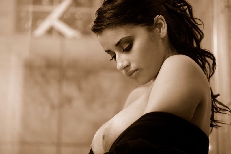 brunette girl wearing a bathrobe in the bathroom