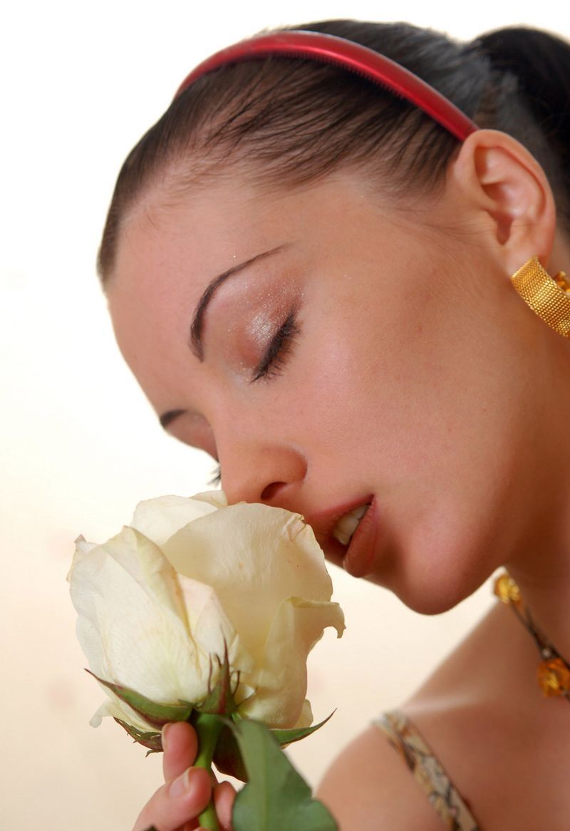 young black haired girl on the couch with a flower