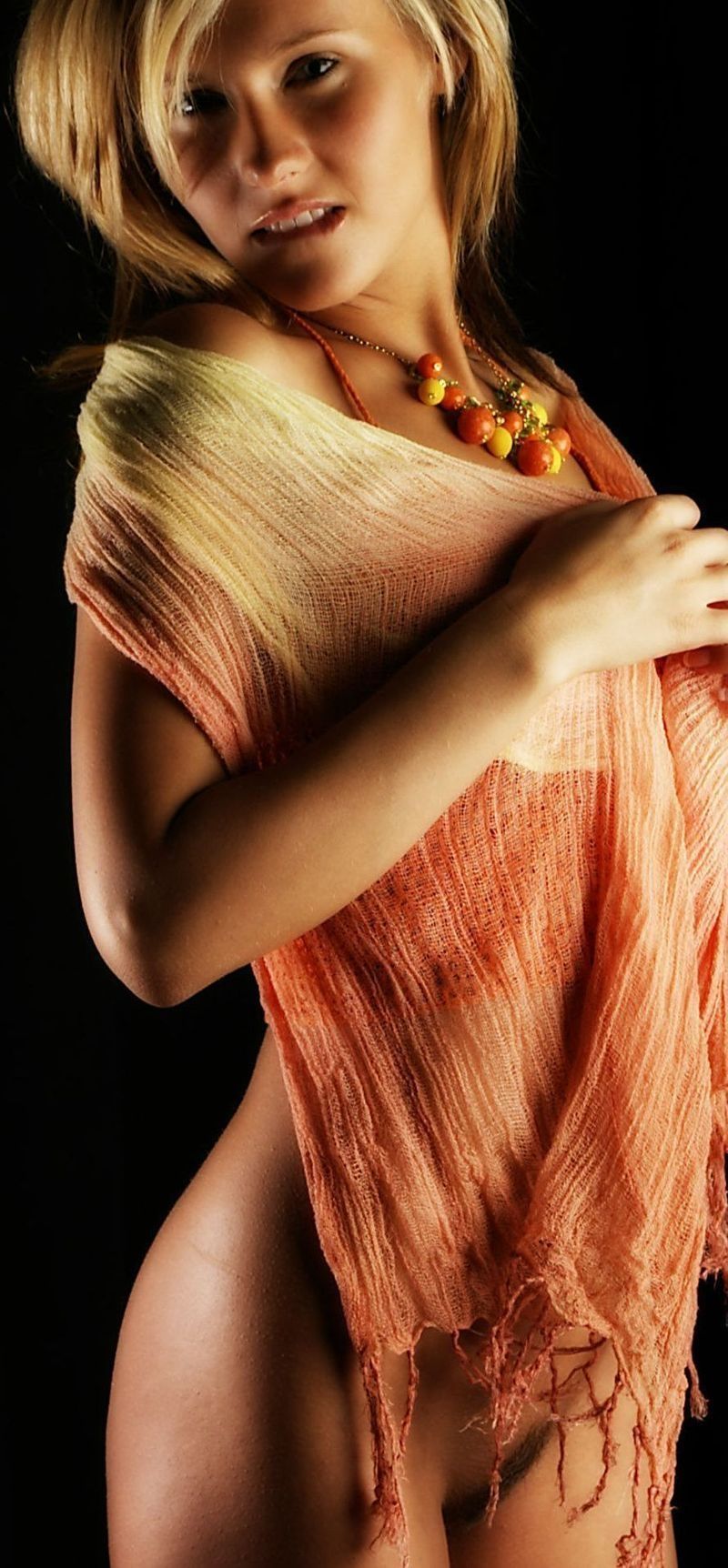 young blonde girl wearing orange knit shirt