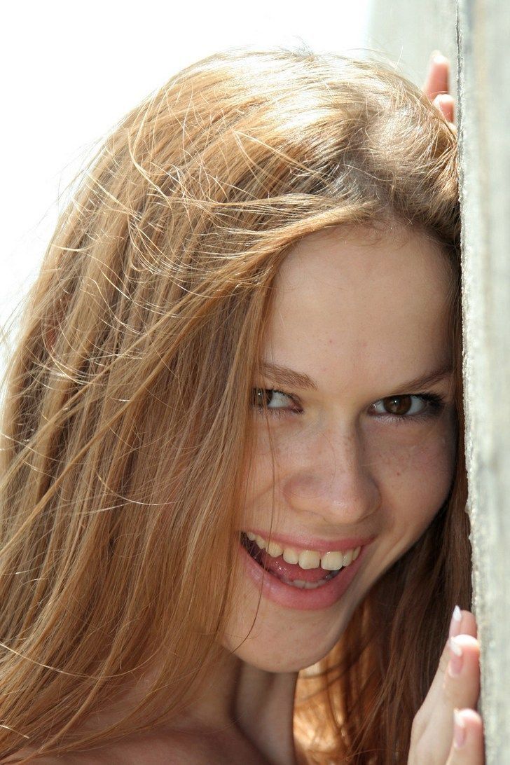 young brunette girl on the wharf by the sea