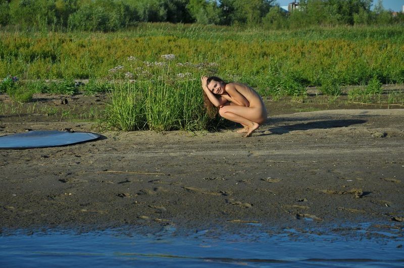 cute young dark blonde girl at the photo shoot in the lake