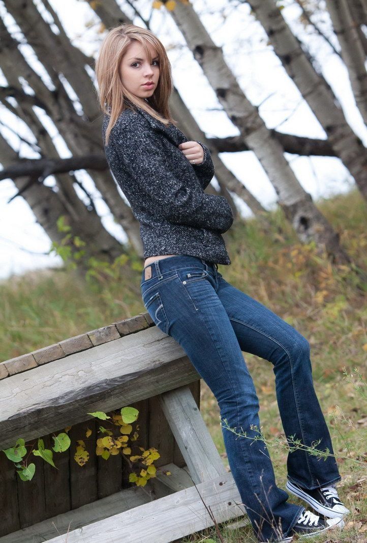 young blonde girl outside in the autumn fall nature