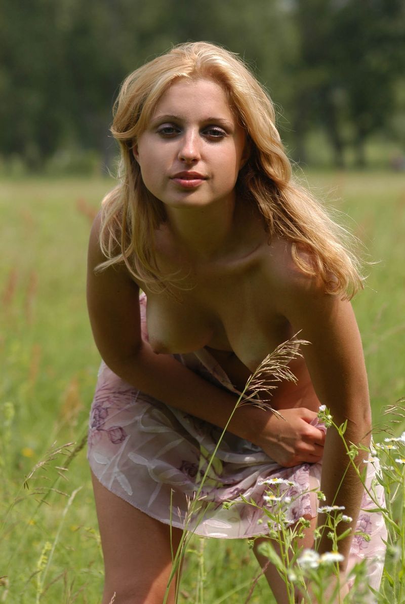 young blonde girl outside on the field