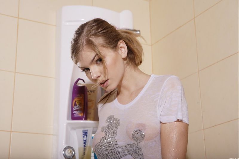 cute young blonde girl having a shower in the bathroom