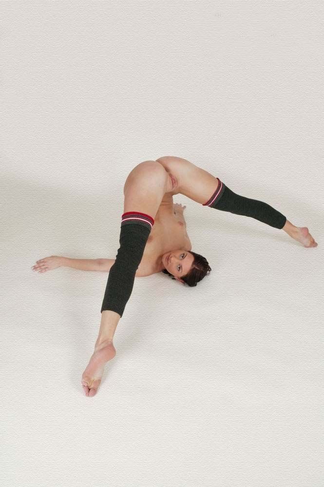 young brunette girl doing gymnastic exercises