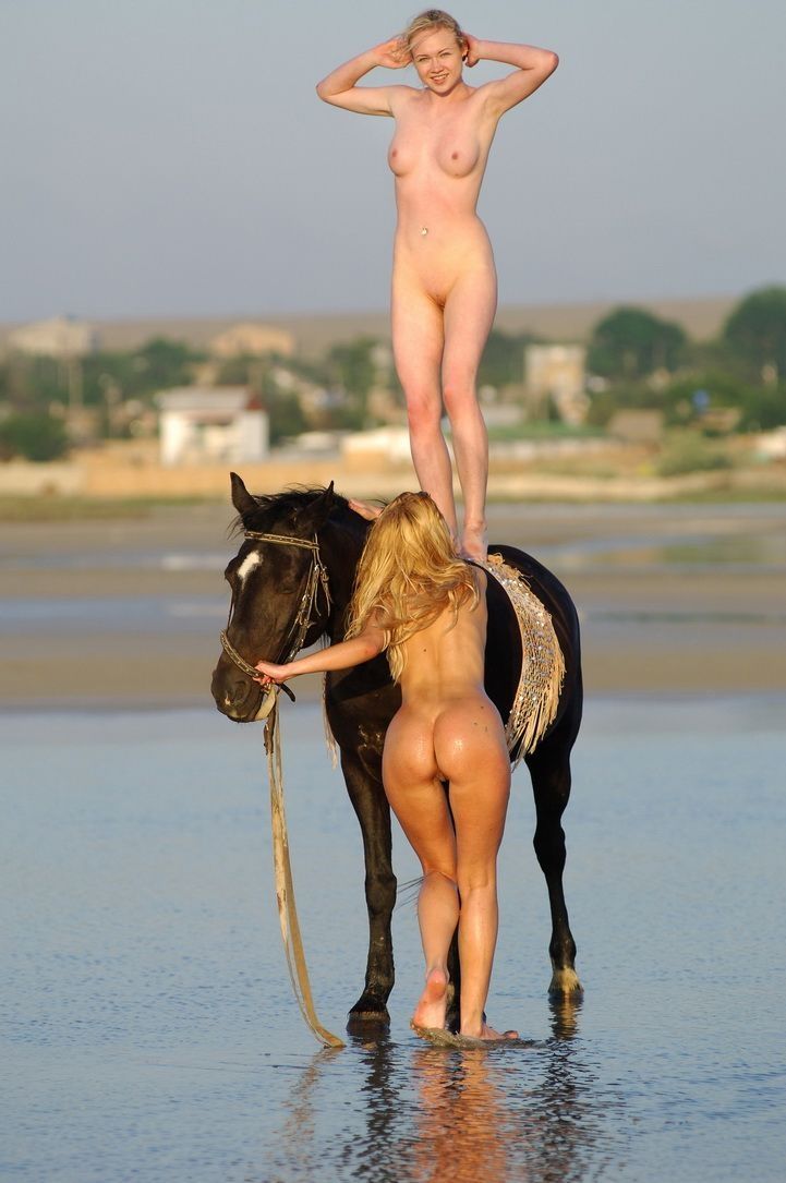 two blonde girls on the beach with a horse