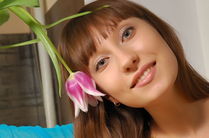 young brunette girl in the kitchen with flowers