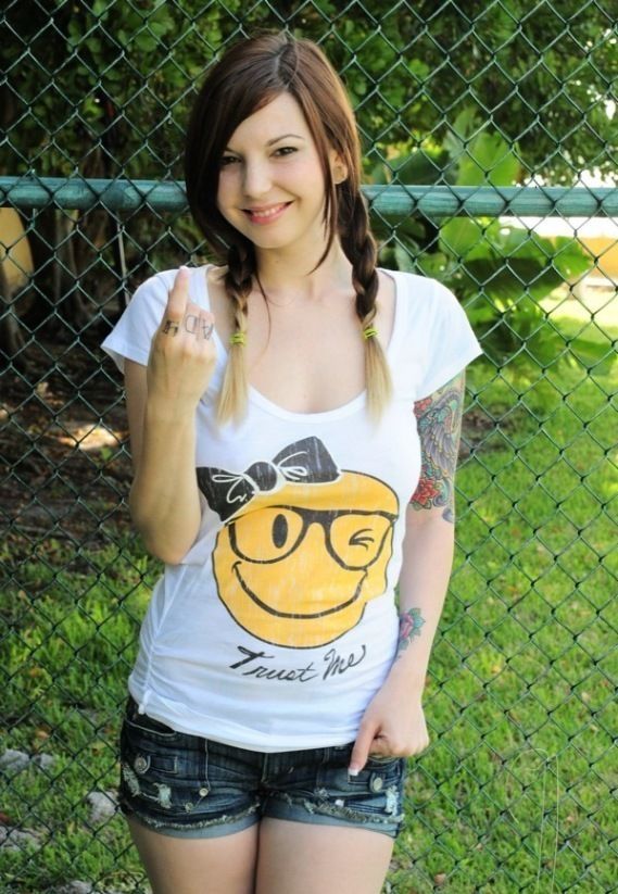 young brunette girl with skin covered by tattoos
