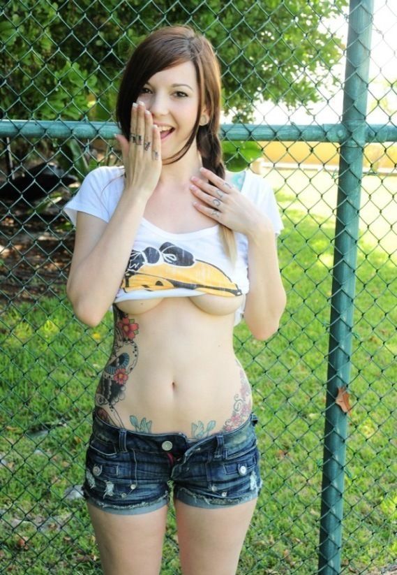 young brunette girl with skin covered by tattoos