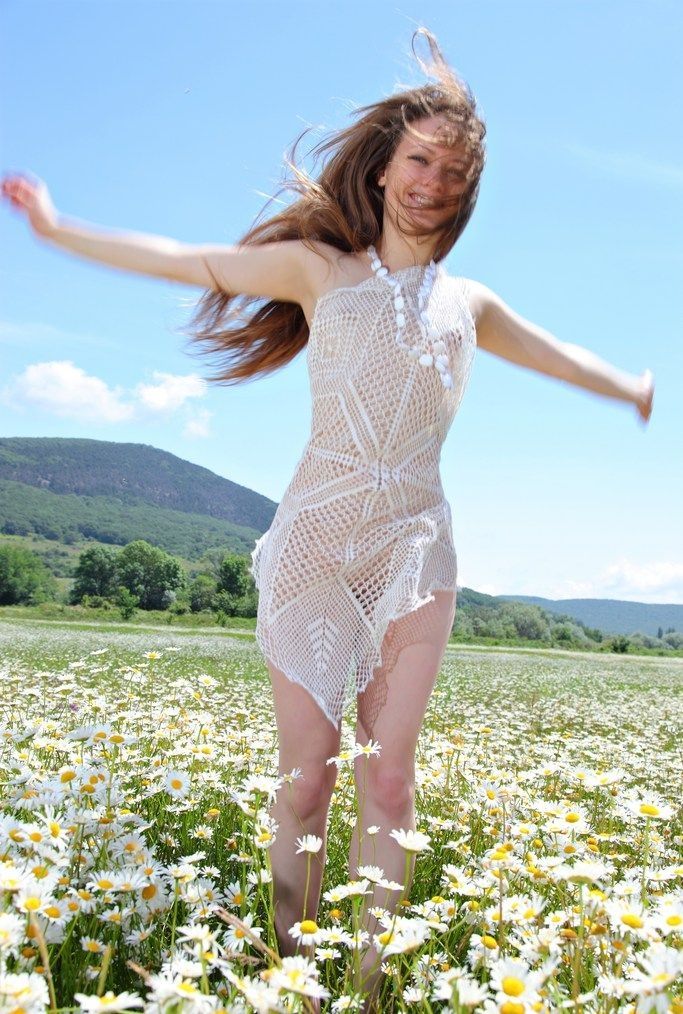 brunette girl on the field of daisy flowers