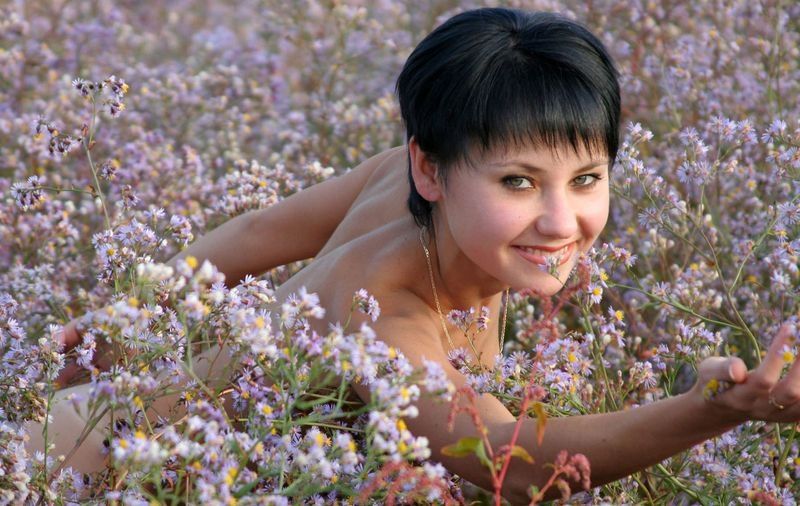 black haired girl in the field of flowers