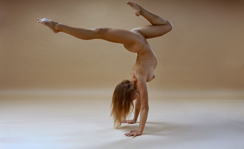 young brunette girl doing flexible gymnastic exercises