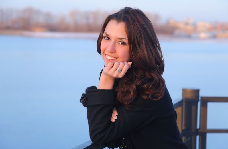 young brunette girl outside near the lake