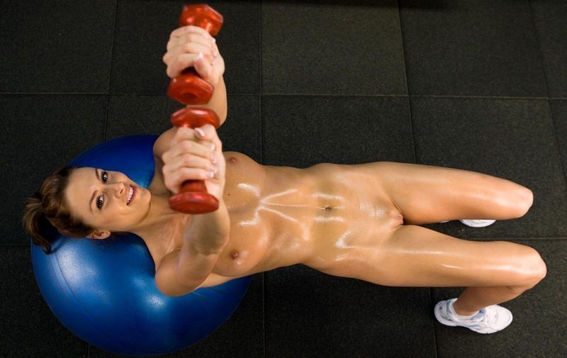 young brunette girl doing workout in the fitness gym