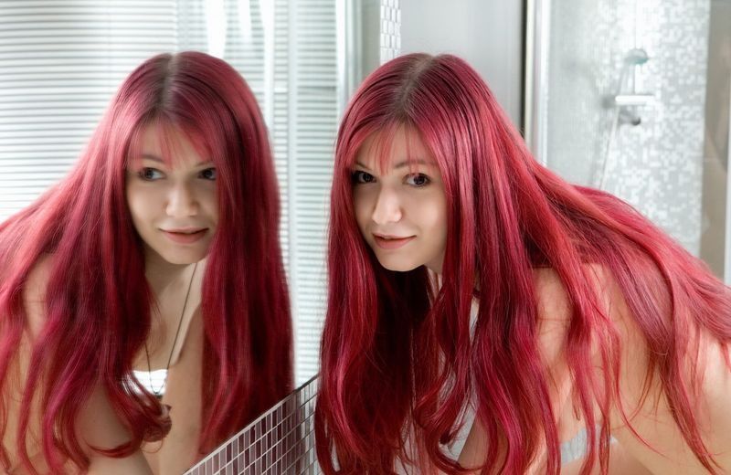 young red haired girl posing in the bathroom