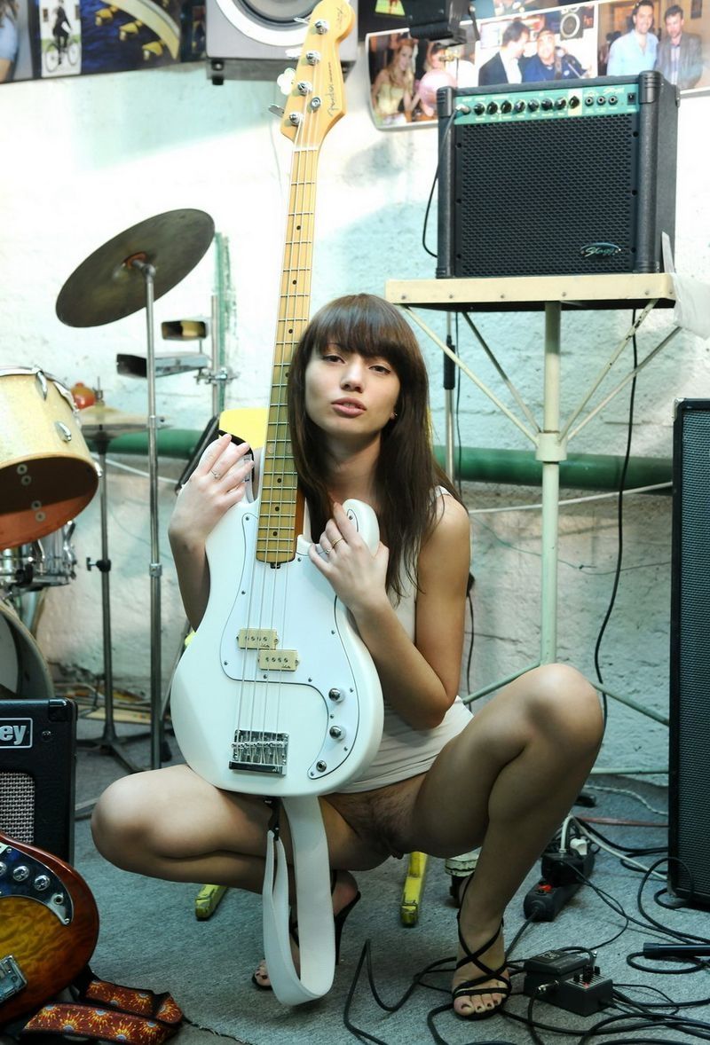brunette girl posing with the guitar