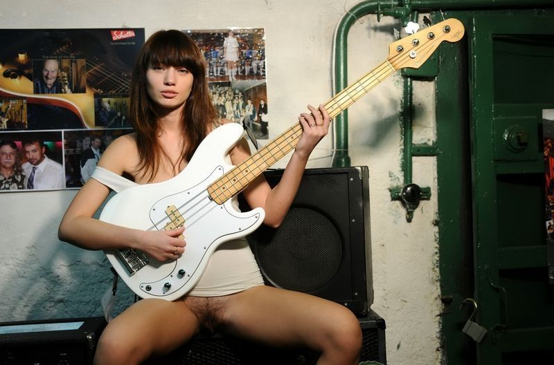 brunette girl posing with the guitar