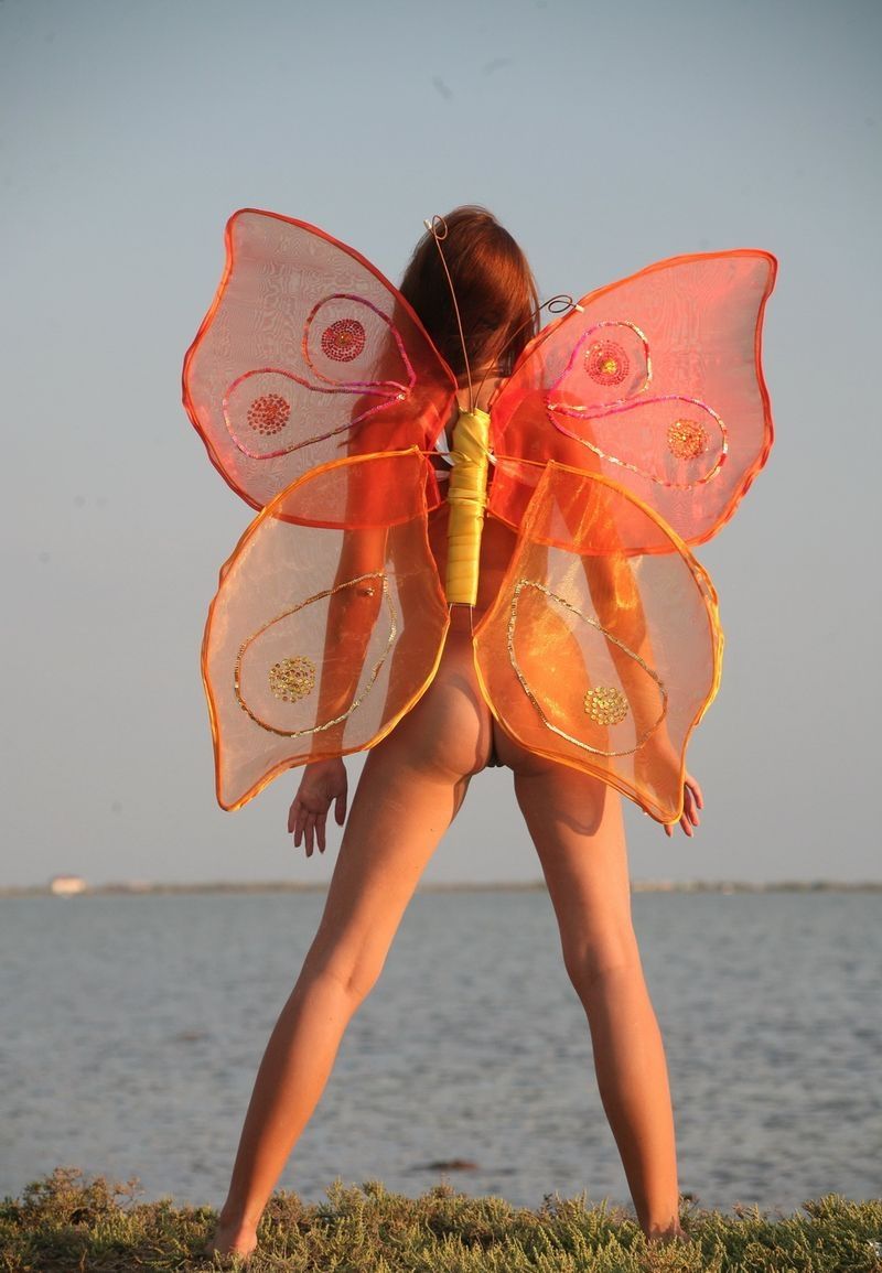 young red haired girl with butterfly wings