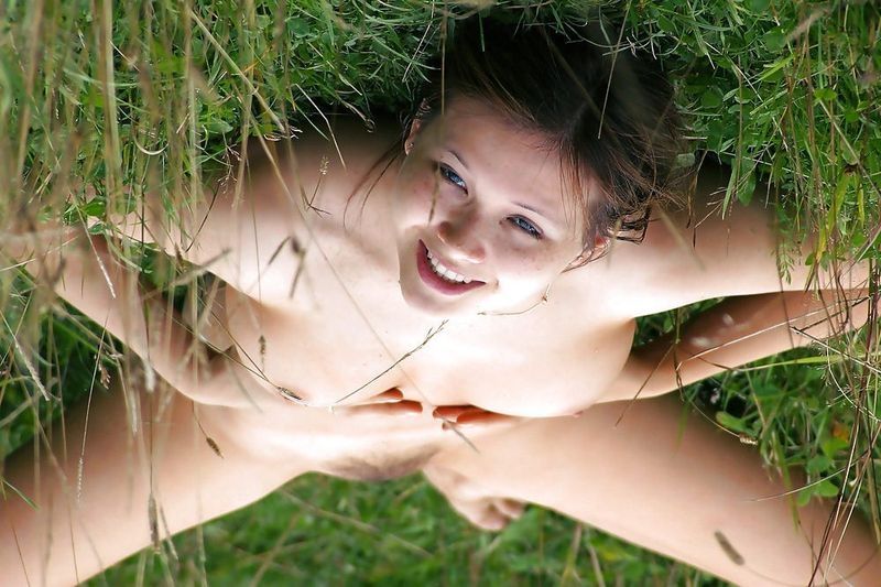 young brunette girl outside on the glade field