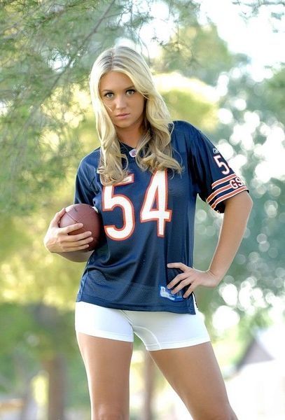 young blonde girl with a rugby oval ball