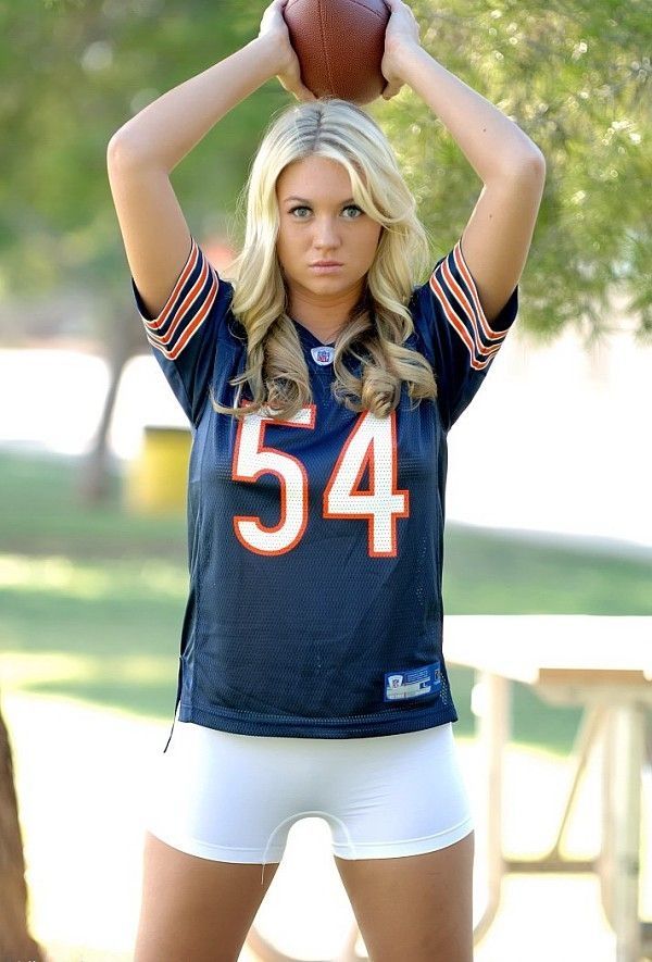 young blonde girl with a rugby oval ball