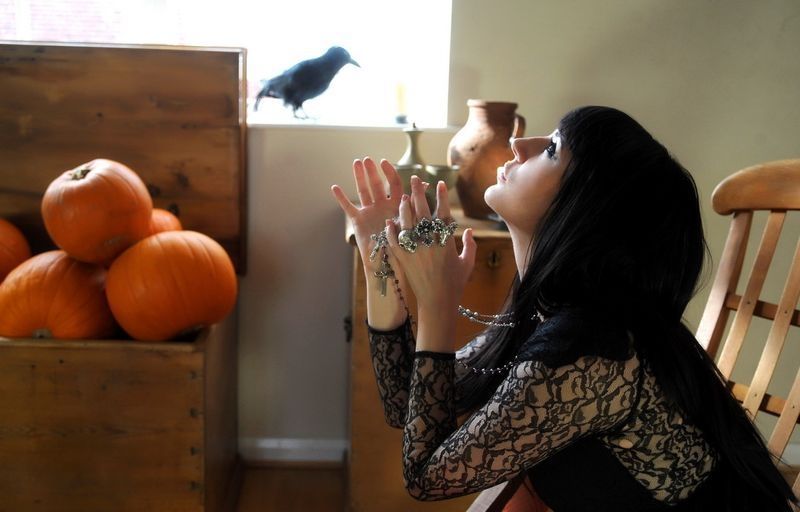 black haired girl with pumpkins and knife