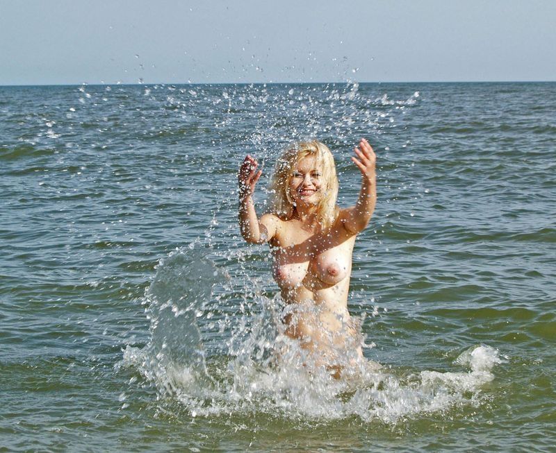 blonde girl posing in the sea