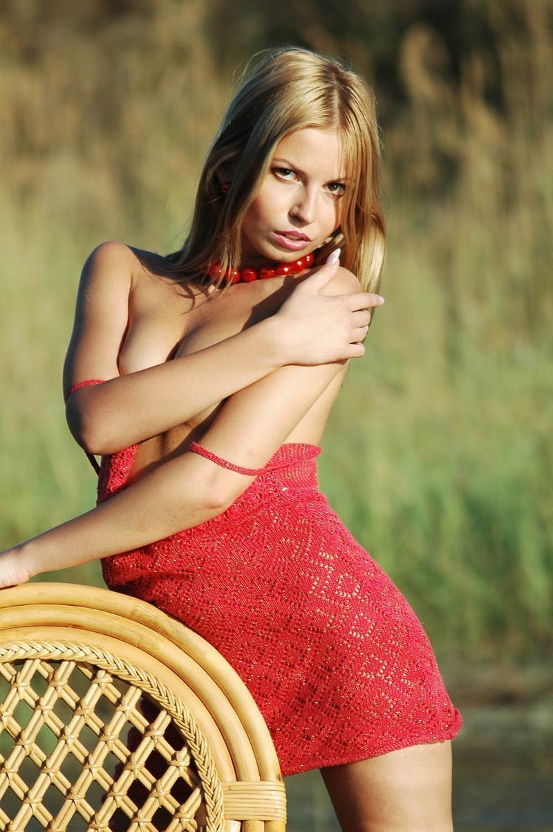 blonde girl in the lake on the wicker chair