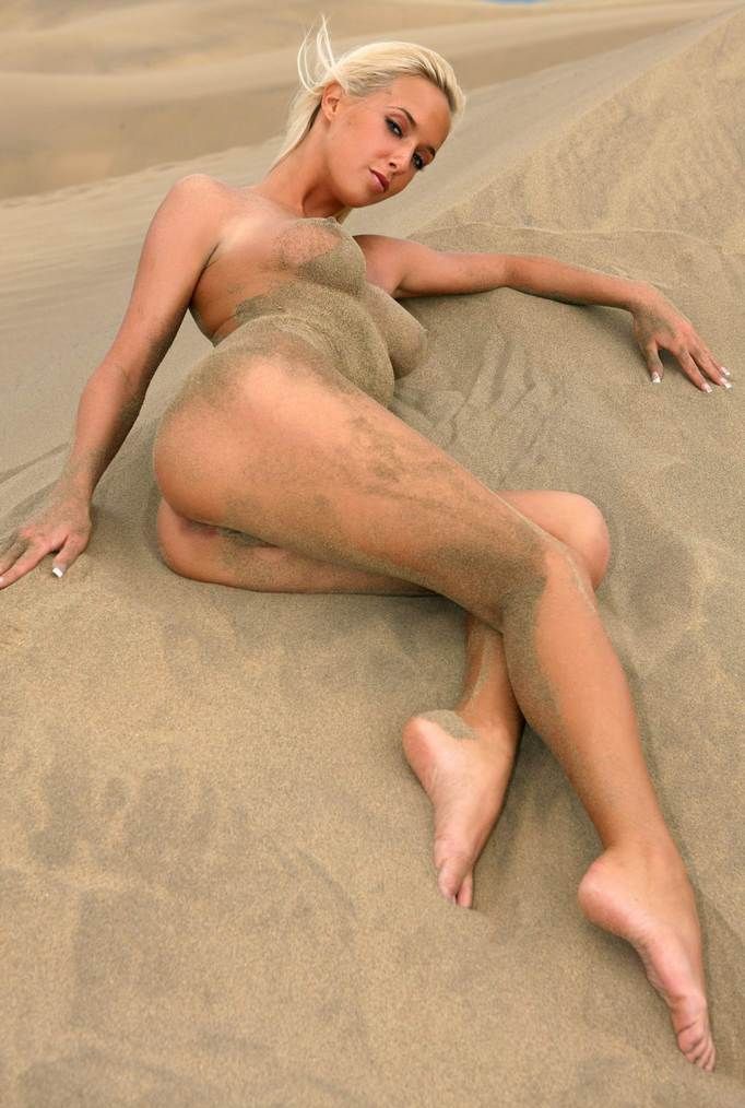 blonde girl naked in desert sand dunes