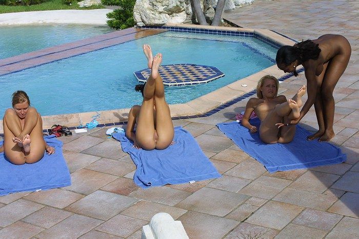 young girls outside at the pool doing physical exercises